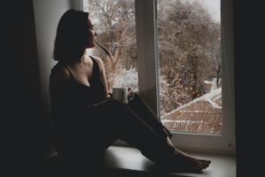Sad Winter Woman in Window